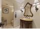 Elegant bathroom showcasing a vintage vanity, ornate mirror, and sconce lighting at 2106 E La Vieve Ln, Tempe, AZ 85284