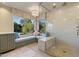 Spacious bathroom featuring large window seat with storage, chandelier, and glass shower at 2106 E La Vieve Ln, Tempe, AZ 85284