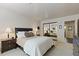 Comfortable bedroom with a queen bed, nightstands, lamps, and a full mirrored closet for ample storage at 2106 E La Vieve Ln, Tempe, AZ 85284