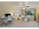 Bright bedroom with glass desk, ceiling fan, and large window at 2106 E La Vieve Ln, Tempe, AZ 85284