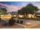 Expansive home exterior with circular driveway, mature trees, and charming curb appeal at 2106 E La Vieve Ln, Tempe, AZ 85284