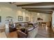 Spacious game room with pool table, shuffleboard, ample seating, and easy access to the outdoor space at 2106 E La Vieve Ln, Tempe, AZ 85284