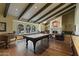 Entertainer's game room featuring a pool table, fireplace, window seating and beamed ceilings at 2106 E La Vieve Ln, Tempe, AZ 85284