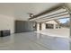 Well-lit garage featuring ample storage cabinets and epoxy floors at 2106 E La Vieve Ln, Tempe, AZ 85284