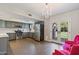 Modern kitchen with stainless steel appliances, gray cabinets, and a chandelier at 2106 E La Vieve Ln, Tempe, AZ 85284