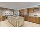 Gourmet kitchen with stone accent wall, large island, custom cabinets, and stainless steel appliances at 2106 E La Vieve Ln, Tempe, AZ 85284