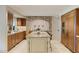 Beautiful kitchen with custom cabinets, granite counters, stone details, and travertine floors at 2106 E La Vieve Ln, Tempe, AZ 85284