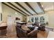 Spacious living room with exposed beam ceiling, fireplace, pool table, and window seats at 2106 E La Vieve Ln, Tempe, AZ 85284