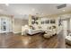 Well-lit living area with wood flooring, featuring a comfortable sectional, and an artistic display of framed photographs at 2106 E La Vieve Ln, Tempe, AZ 85284