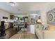 Bright, open-concept living room flows into the dining area and kitchen, featuring hardwood floors and modern decor at 2106 E La Vieve Ln, Tempe, AZ 85284