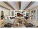 Comfortable living room with beamed ceilings, built-in display shelving, stylish sofas, and seamless indoor-outdoor living at 2106 E La Vieve Ln, Tempe, AZ 85284