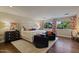 Spacious main bedroom with a king bed, reading chairs, wood floors, and large windows for a luxurious feel at 2106 E La Vieve Ln, Tempe, AZ 85284