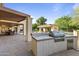 Spacious outdoor kitchen and patio area with a built-in grill, perfect for outdoor entertaining at 2106 E La Vieve Ln, Tempe, AZ 85284