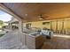 Cozy covered patio with comfortable seating, ceiling fan, and access to a pool at 2106 E La Vieve Ln, Tempe, AZ 85284