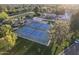 Overhead view of community tennis courts with manicured lawns and verdant foliage at 2106 E La Vieve Ln, Tempe, AZ 85284