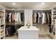 Organized walk-in closet with central island and custom shelving, providing ample storage at 2106 E La Vieve Ln, Tempe, AZ 85284