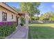 Lush backyard landscaping with stone path, green lawn, and exterior home details at 2106 E La Vieve Ln, Tempe, AZ 85284