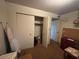 Modest bedroom with cluttered walk-in closet at 2141 W Elm St, Phoenix, AZ 85015