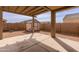 Spacious backyard featuring a storage shed, large brick wall, and covered patio at 2220 N St Bonita Ln, Casa Grande, AZ 85122
