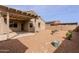 Low maintenance backyard with covered patio, desert landscaping, and privacy wall at 2220 N St Bonita Ln, Casa Grande, AZ 85122