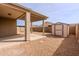 Backyard featuring a large storage shed, covered patio, and rock landscaping at 2220 N St Bonita Ln, Casa Grande, AZ 85122