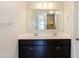 Updated bathroom features dual sinks, quartz countertops, dark cabinets and chrome hardware at 2220 N St Bonita Ln, Casa Grande, AZ 85122
