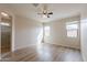 Bright, spacious bedroom with hardwood floors, ceiling fan, and natural light at 2220 N St Bonita Ln, Casa Grande, AZ 85122