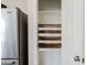 View of a walk-in pantry with pull out shelving, next to a refrigerator at 2220 N St Bonita Ln, Casa Grande, AZ 85122