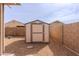 New storage shed in backyard featuring grey trim, fresh paint, and rock landscaping at 2220 N St Bonita Ln, Casa Grande, AZ 85122