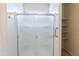 Modern frosted glass shower in a bathroom featuring tile floors and built-in shelving at 2220 N St Bonita Ln, Casa Grande, AZ 85122