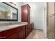 Bathroom featuring granite countertops, dark wood cabinets, and a tiled shower at 2309 W Shawnee Dr, Chandler, AZ 85224