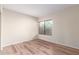A secondary bedroom featuring wood laminate flooring and a window at 2309 W Shawnee Dr, Chandler, AZ 85224