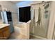 The bathroom features a shower, a bathtub, and blue storage at 2348 W Alta Vista Rd, Phoenix, AZ 85041