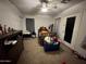 A bedroom featuring neutral walls, ceiling fan, and a blue storage container at 2348 W Alta Vista Rd, Phoenix, AZ 85041