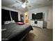 Bedroom with carpet, a ceiling fan, and television across from the queen-sized bed at 2348 W Alta Vista Rd, Phoenix, AZ 85041