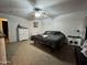 A cozy bedroom features neutral carpeting, a ceiling fan, and a comfortable queen-size bed at 2348 W Alta Vista Rd, Phoenix, AZ 85041