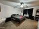 Bedroom with dark accents and a comfy queen-sized bed on plush neutral carpeting at 2348 W Alta Vista Rd, Phoenix, AZ 85041