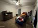 A spacious bedroom featuring neutral walls, ceiling fan, and a dresser at 2348 W Alta Vista Rd, Phoenix, AZ 85041