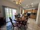 Open kitchen with wooden cabinets, a round breakfast table, and access to the backyard at 2348 W Alta Vista Rd, Phoenix, AZ 85041