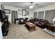 Comfortable living room featuring a ceiling fan and stylish leather furniture at 2348 W Alta Vista Rd, Phoenix, AZ 85041