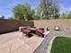 Outdoor patio features a stone fire pit with seating, a decorative metal sun, and a low-maintenance gravel border at 2348 W Alta Vista Rd, Phoenix, AZ 85041