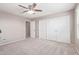 Spacious bedroom featuring closet doors and a ceiling fan, perfect for relaxation at 2425 E Flintlock Dr, Gilbert, AZ 85298