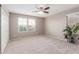 Large bedroom with ample natural light, and a ceiling fan for comfortable climate control at 2425 E Flintlock Dr, Gilbert, AZ 85298