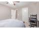 A secondary bedroom features neutral walls, carpeted floor, and a desk with computer at 2425 E Flintlock Dr, Gilbert, AZ 85298