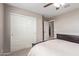Bedroom featuring closet doors and easy access to the laundry room at 2425 E Flintlock Dr, Gilbert, AZ 85298