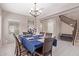 Formal dining room featuring elegant chandelier, staircase, and space for gathering with Gathering and friends at 2425 E Flintlock Dr, Gilbert, AZ 85298