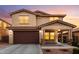 Beautiful two-story home with a large garage, covered porch, and desert landscaping at 2425 E Flintlock Dr, Gilbert, AZ 85298