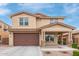 Two-story home boasting a large garage, covered porch, and well-maintained landscaping at 2425 E Flintlock Dr, Gilbert, AZ 85298