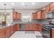 Spacious kitchen boasts granite countertops, tile backsplash, stainless steel appliances, and ample cabinet storage at 2425 E Flintlock Dr, Gilbert, AZ 85298