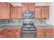 Close-up view of the kitchen featuring stainless steel appliances, granite countertops, and tile backsplash at 2425 E Flintlock Dr, Gilbert, AZ 85298